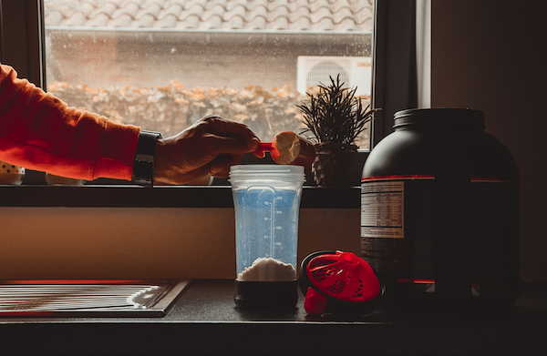 Shake Bottle Being Filled with Powder | Whey Protein Weight Loss