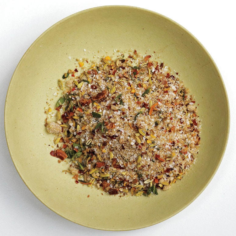 Dry brine in a bowl with whole fennel seeds and crushed chiles.