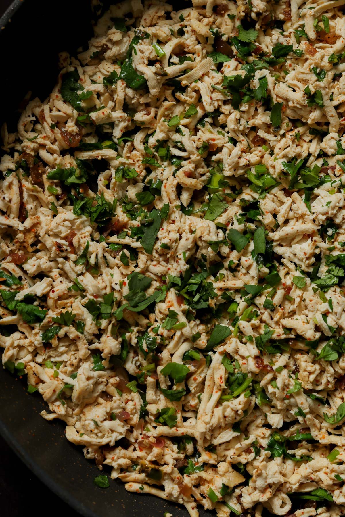 close-up of cilantro lime shredded tofu in a pan after cooking