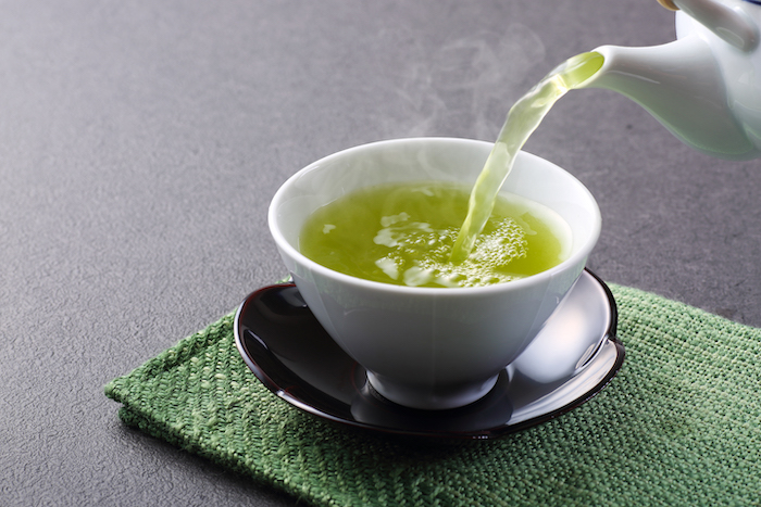 Cup of Green Tea Being Poured