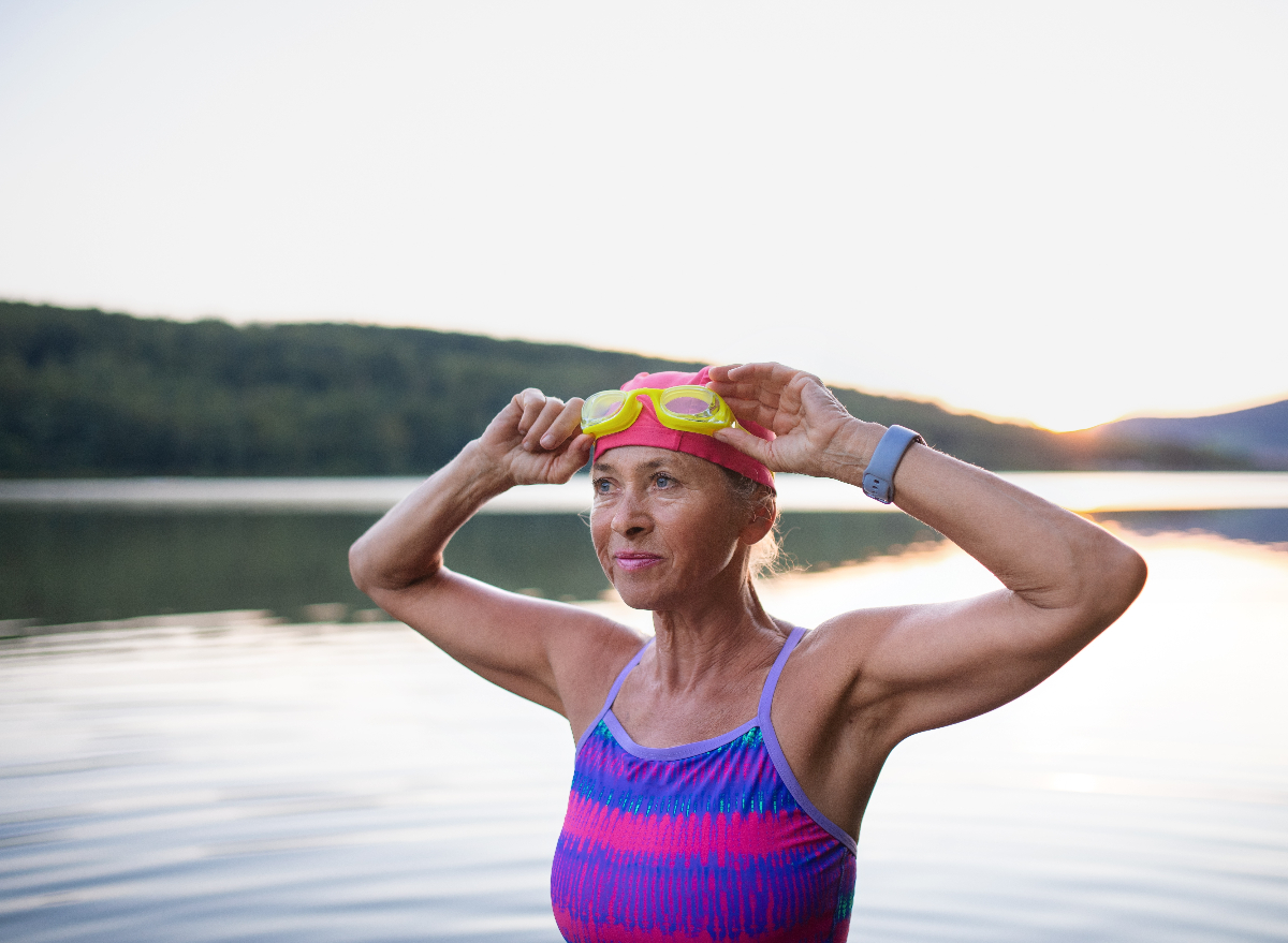 mature fit woman swimming outdoors