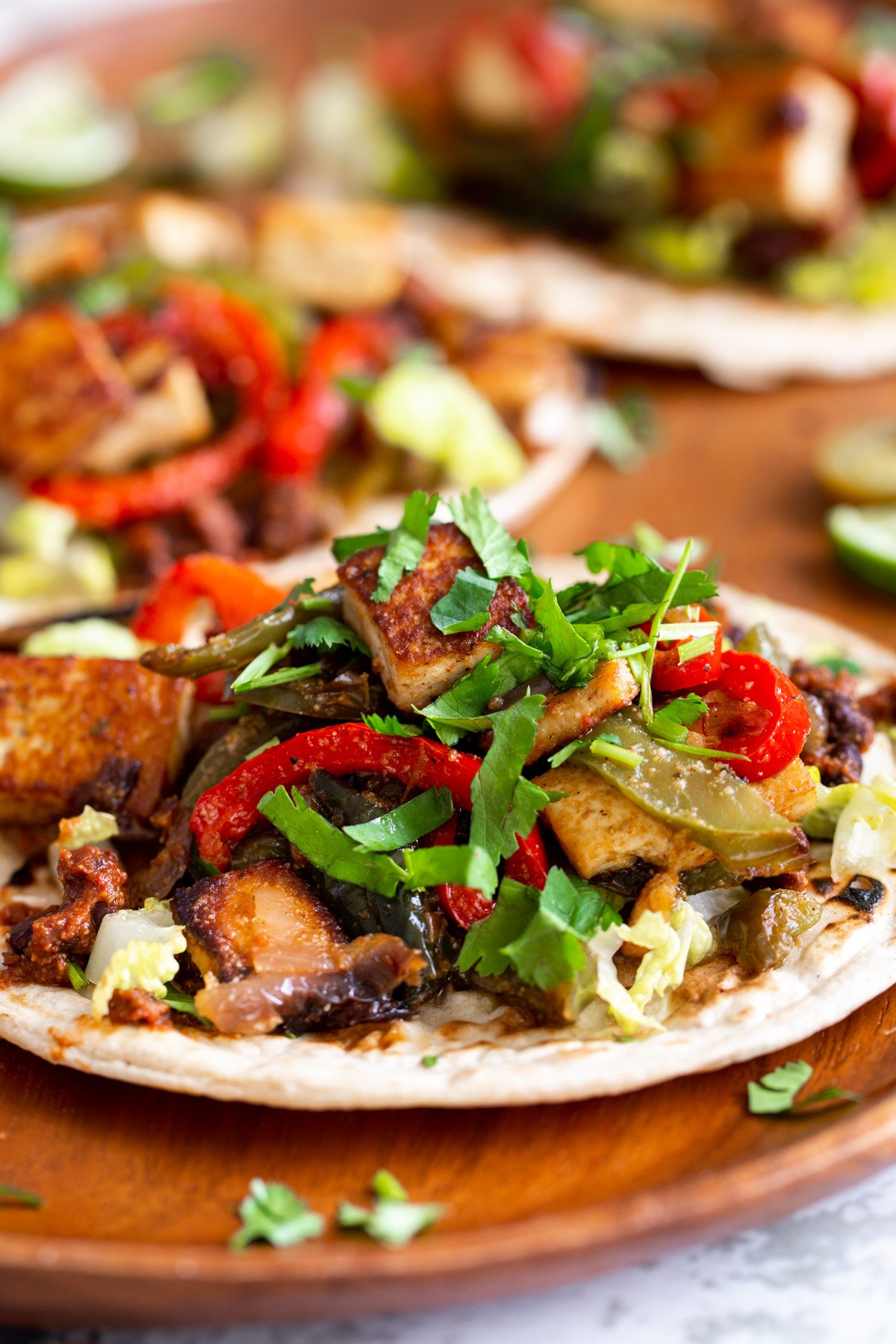 side view of a vegan tofu taco with sauteed bell pepper and chopped cilantro 