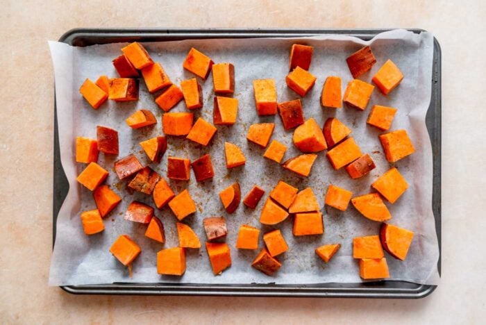 Cubed sweet potato on a baking sheet.