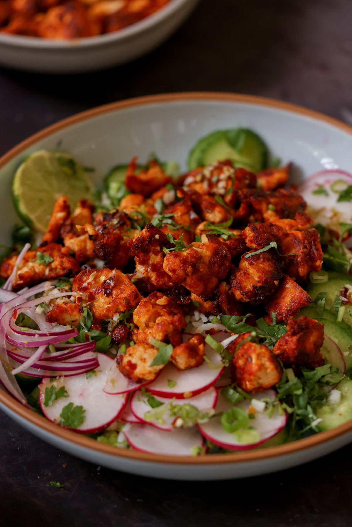 harissa tofu bowl with fresh veggies and herbed rice