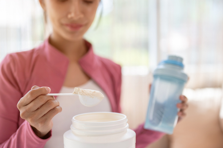 Close Up of Woman Scooping Creatine | Is Creatine Safe for Women