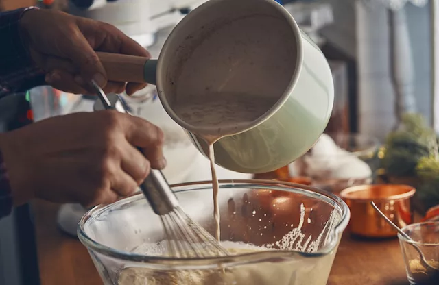 how to make eggnog. A woman making eggnog.