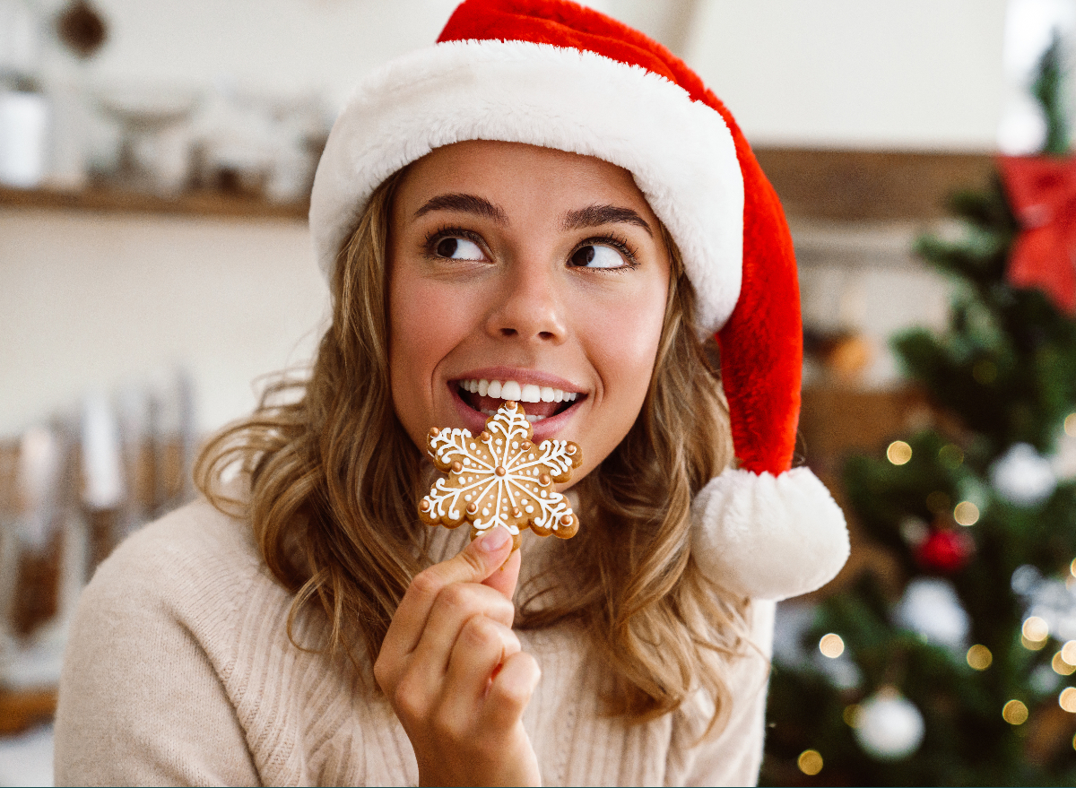 woman eating gingerbread christmas cookie