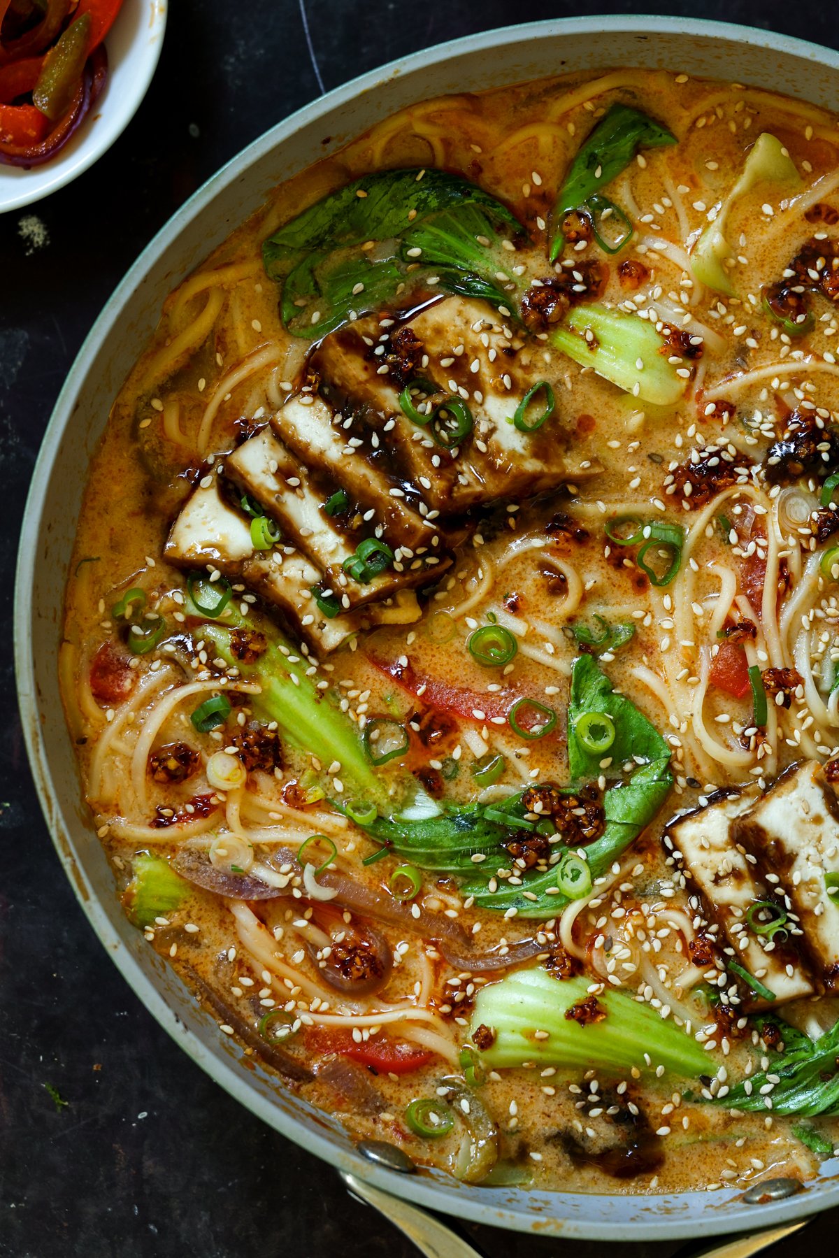 close-up of a panful of creamy tahini ramen with teriyaki tofu on top