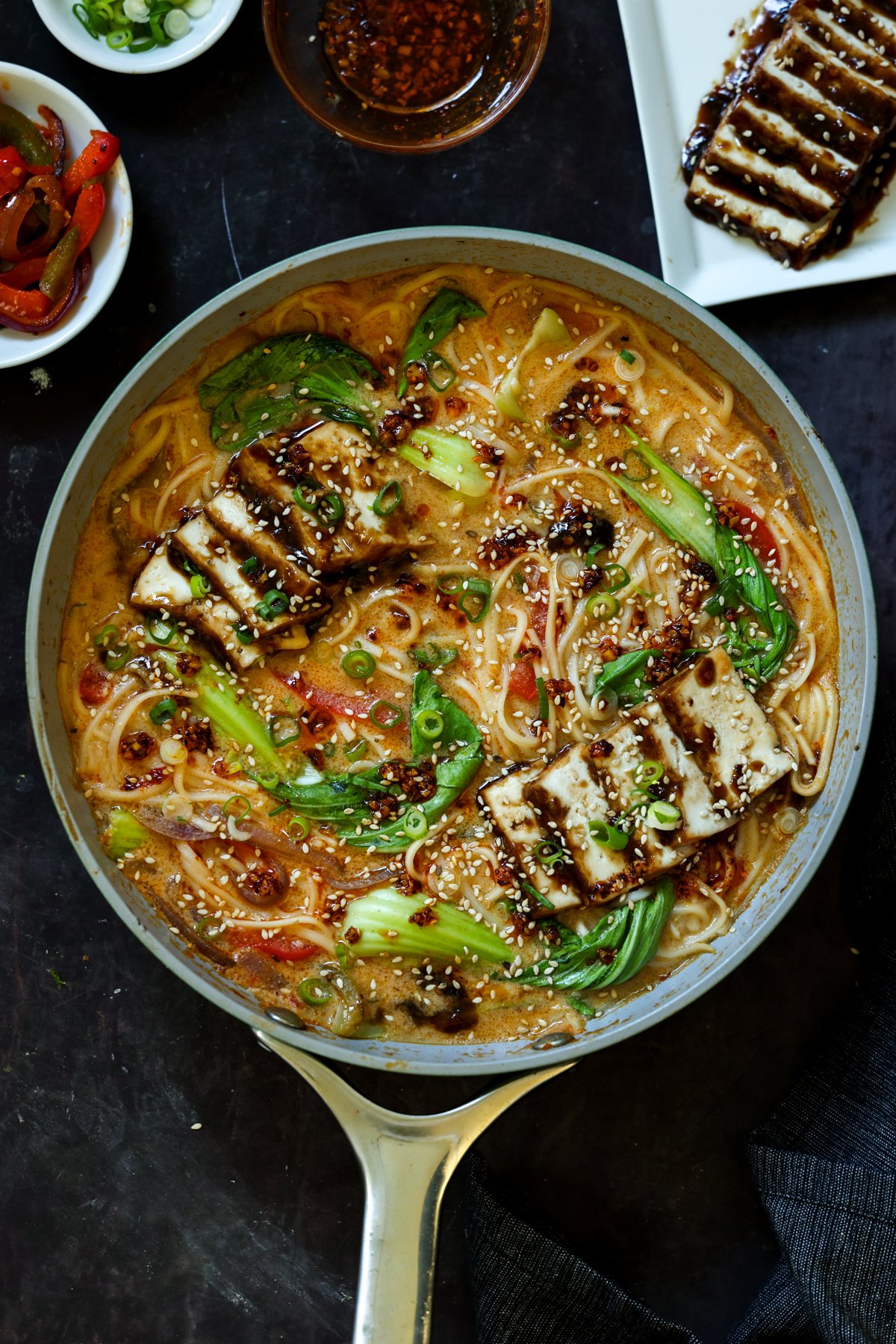 panful of creamy tahini ramen with teriyaki tofu on top