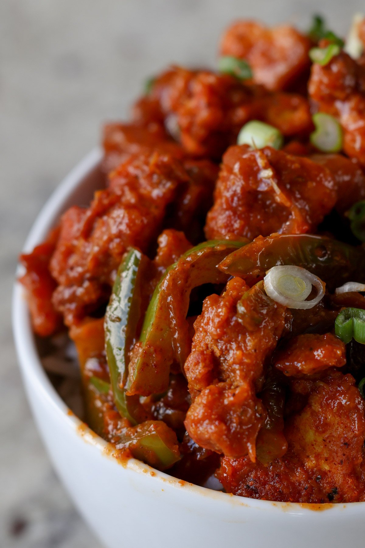 extreme close-up of tofu kondattam in a bowl over rice