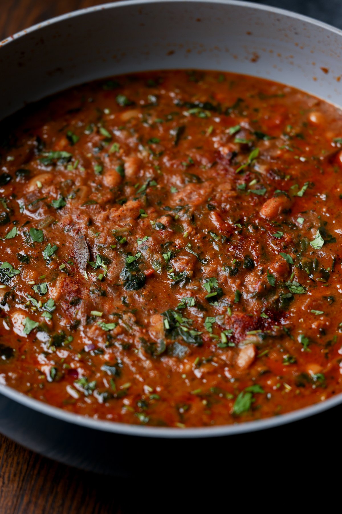 close-up of lentil bean stew in the pan after cooking and garnishing