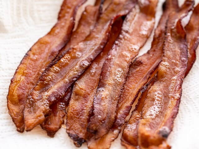Bacon strips on a plate covered with paper towel